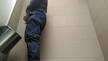 Young guy peeing with his uncut cock in a highway toilet